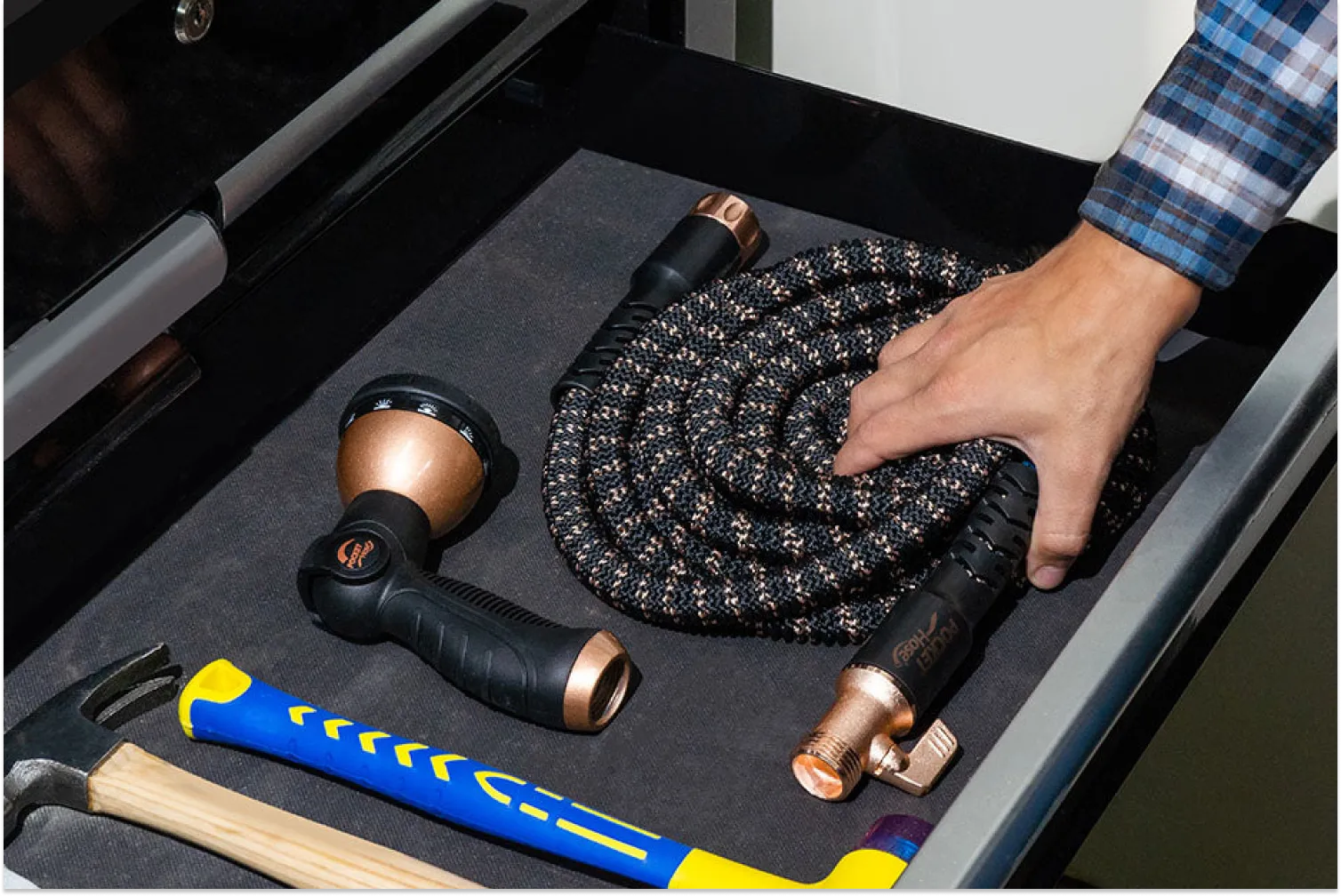 Man storing expandable hose properly to extend lifespan and prevent damage