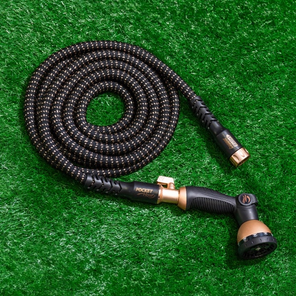 Copper Bullet 10-Pattern Sprayer attached to the Copper Bullet hose coiled compactly on a lawn