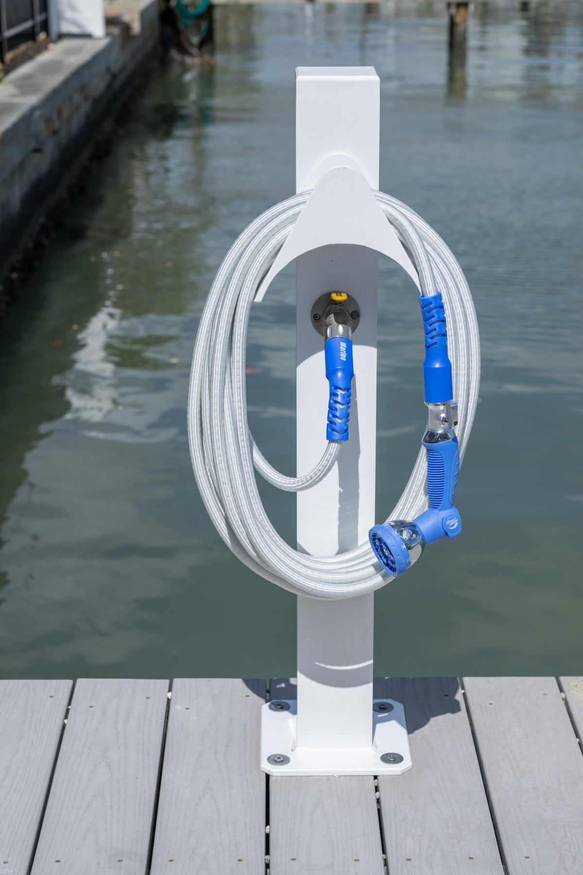 Marine Hose and 10 Pattern Spray Nozzle, coiled and hung neatly on a dock