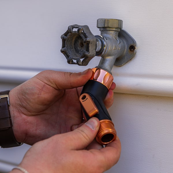 Copper Bullet Elbow Connector being installed on spigot