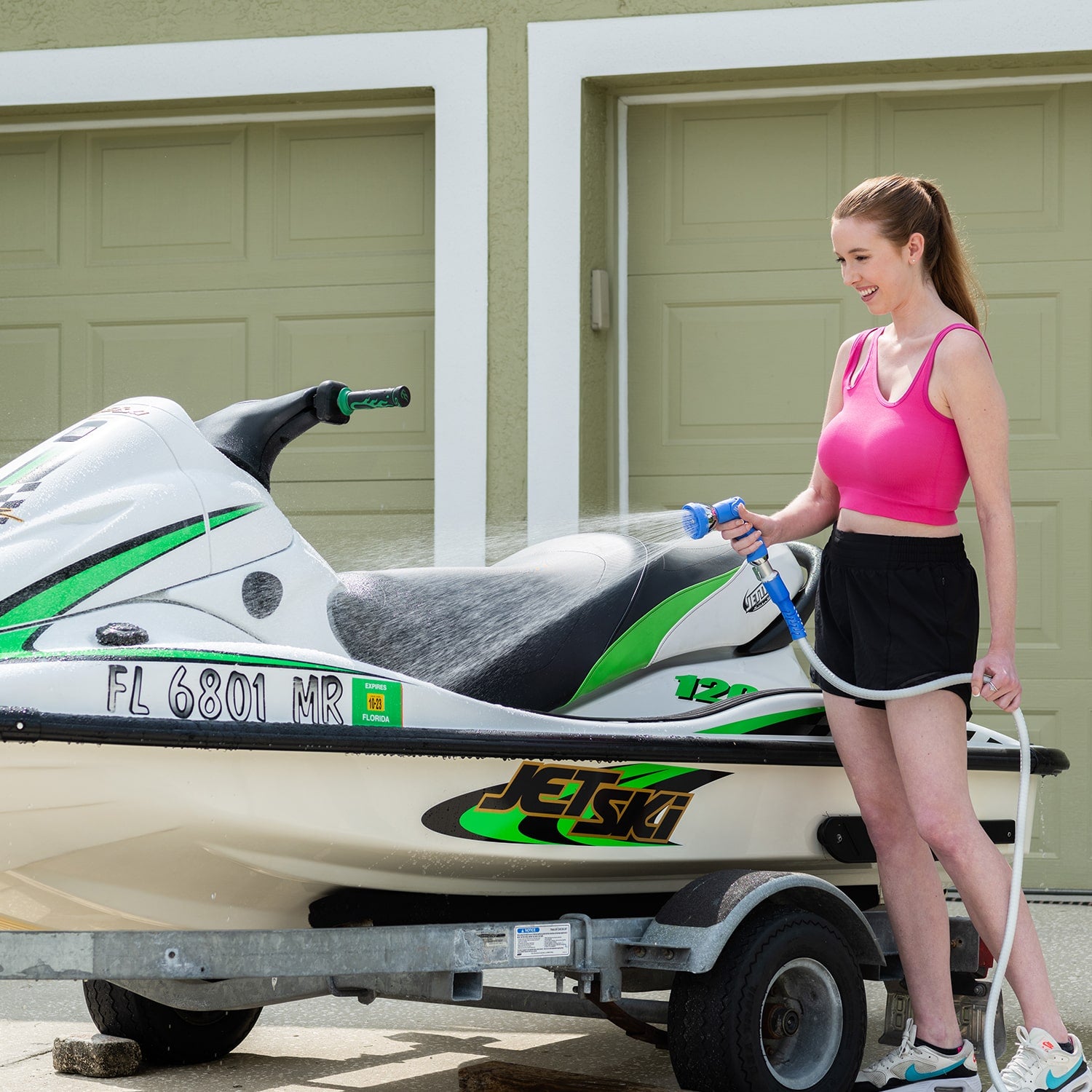 Marine Hose in use by woman cleaning jetski